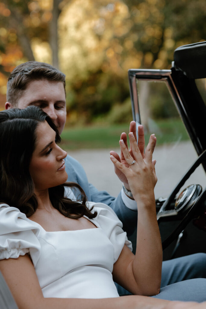 future bride and groom sit in vintage car with eachother at Bradley Estate Engagement Photos