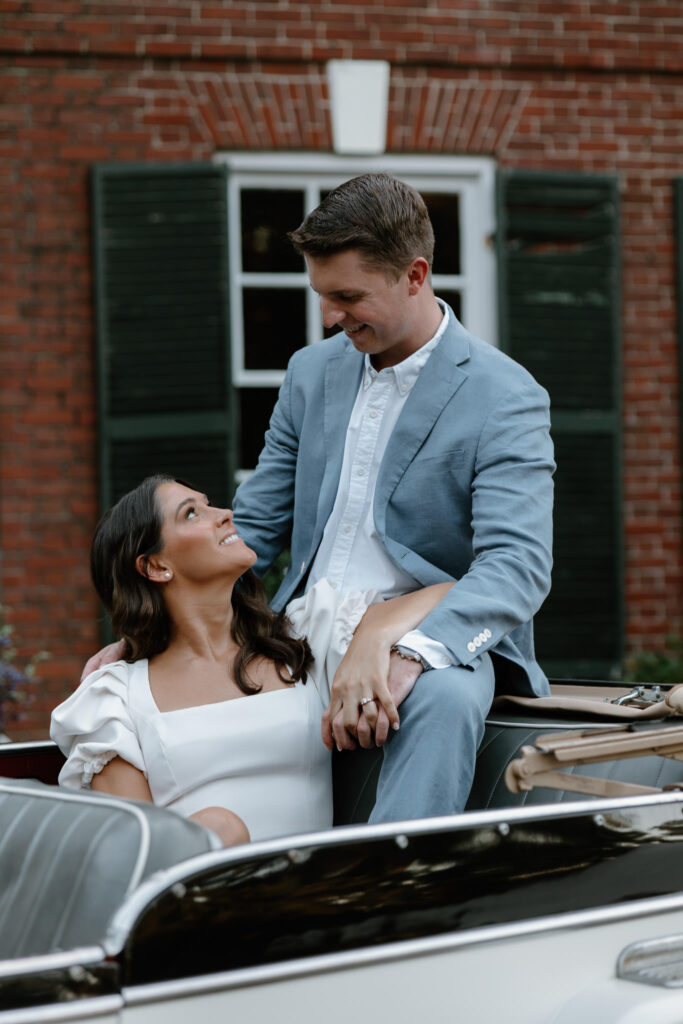 Couple sits in the back of a vintage car at retro Bradley Estate Engagement Photos