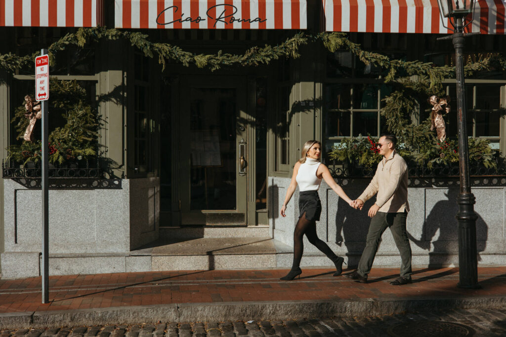 Walking outside of Ciao Roma in Boston North End Engagement Photos 