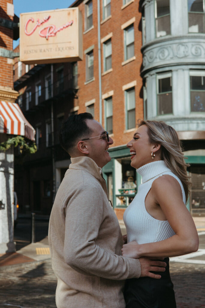 Couple laughs together in Boston North End Engagement