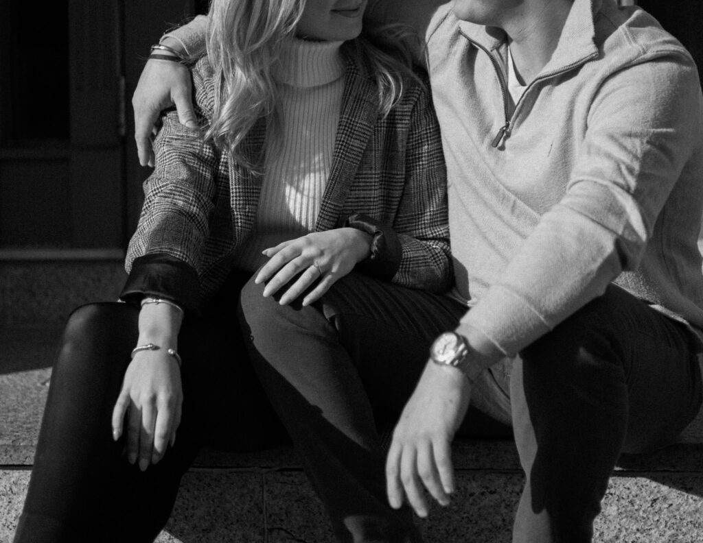 Couple sits together for engagement photos during Boston North End Engagement Photos 