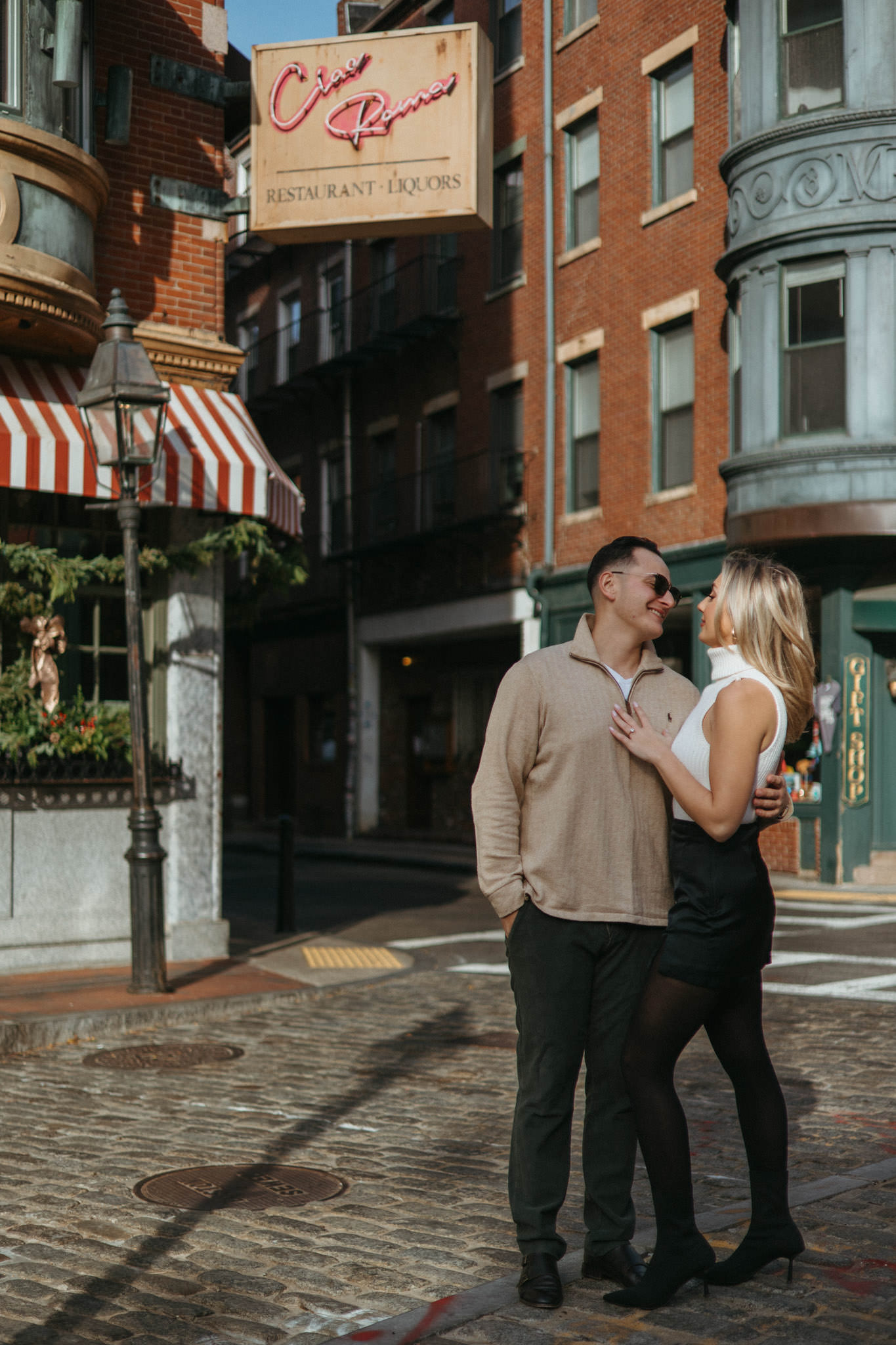 Couple poses together on a warm sunny day in December for Boston North End Engagement Photos