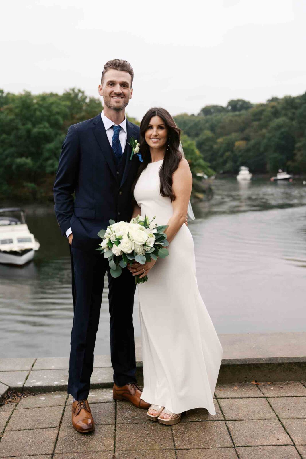 Bride and groom pose for traditional wedding portrait at intimate restaurant wedding