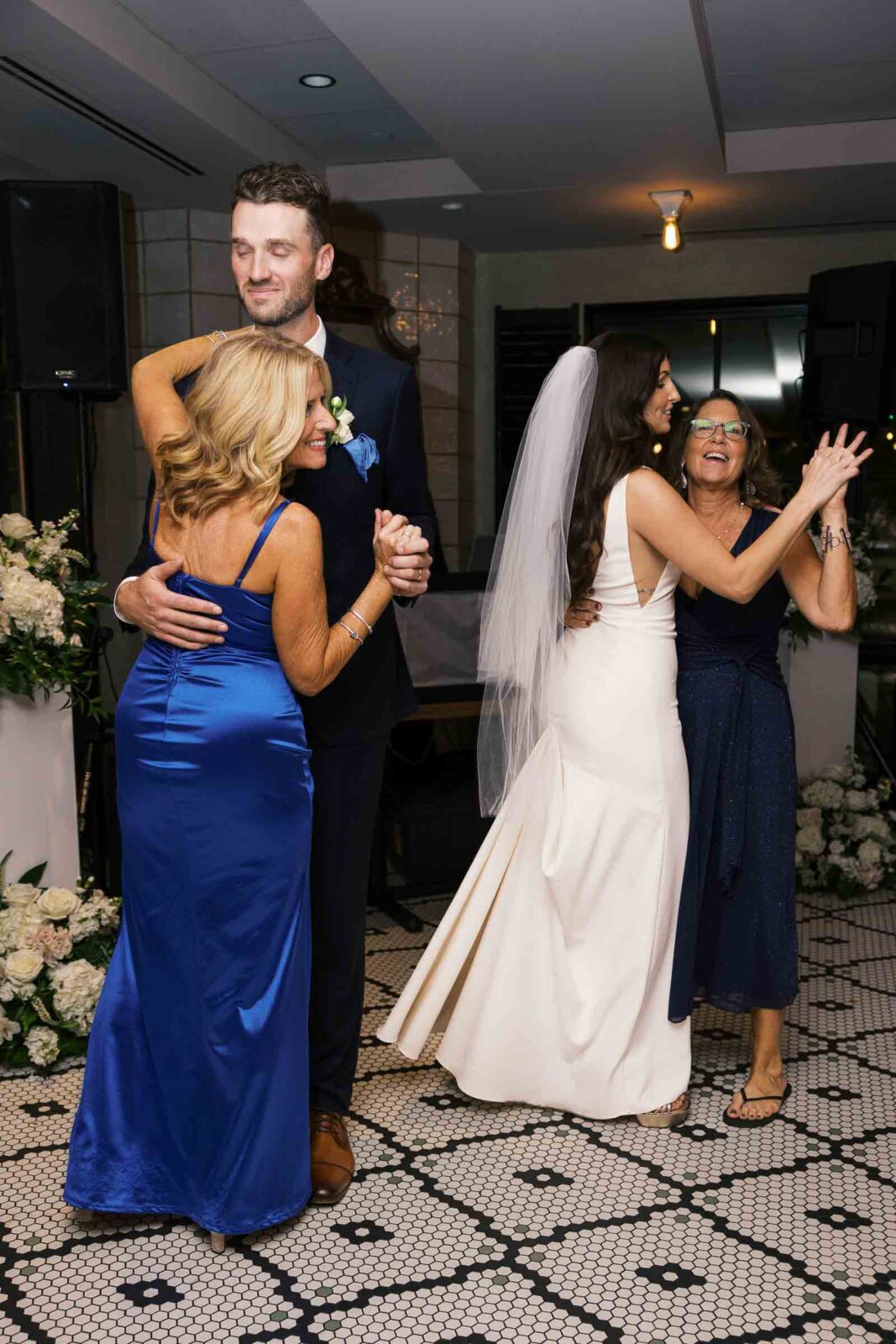 Bride & Groom dance with their moms for the first time at intimate restaurant wedding