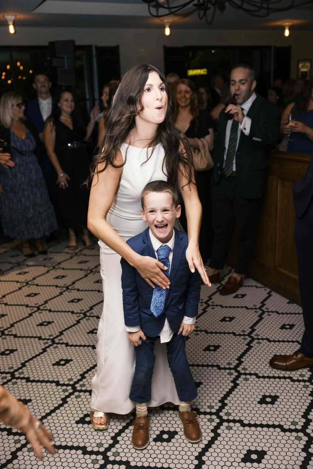 Bride dances with her son at intimate restaurant wedding