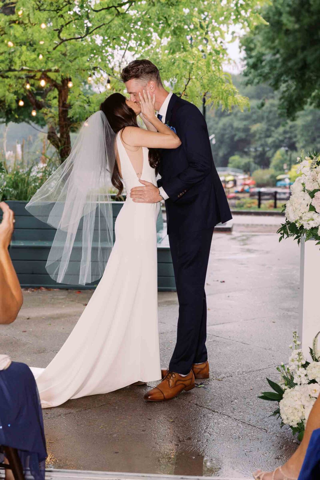 Bride and groom kiss at intimate restaurant wedding