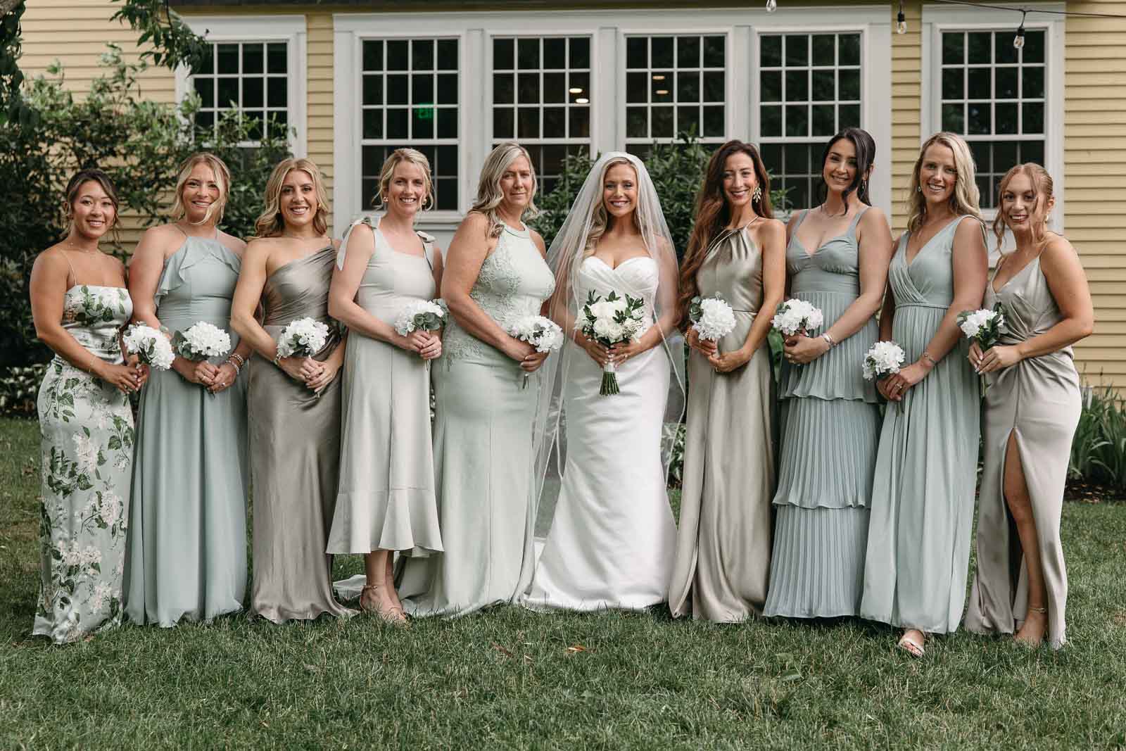 The Bridesmaids in mix-matching dresses for a sage-inspired wedding