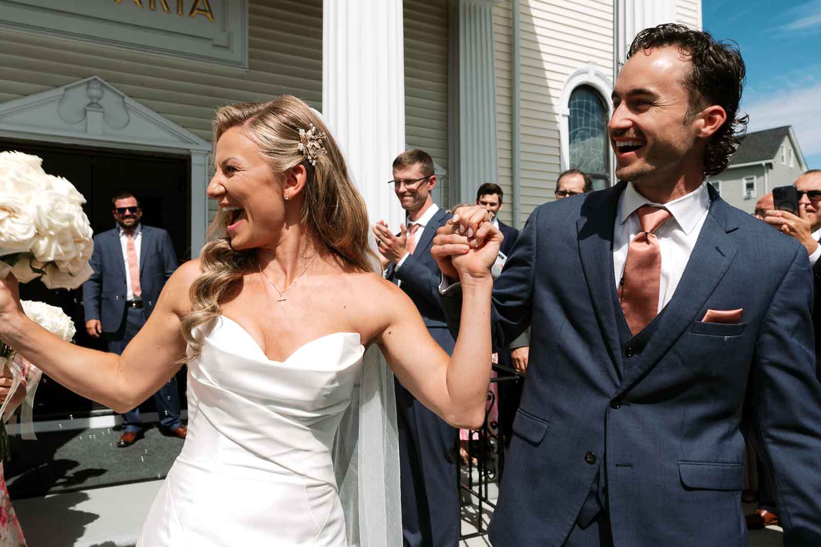 Bride and groom celebrate with their people after church wedding ceremony | Grand View Mendon MA Wedding